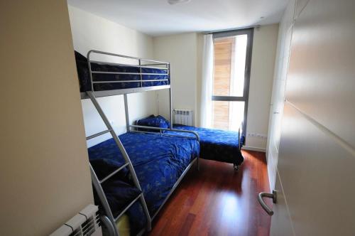 a bedroom with two bunk beds and a window at Apartamento mirador del valle wowrural in Sabiñánigo