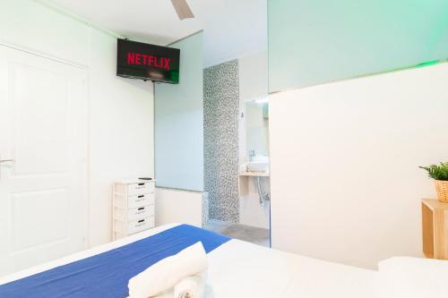 a bedroom with a bed and a sign on the wall at Guest house Villa Neon Tenerife in Arona