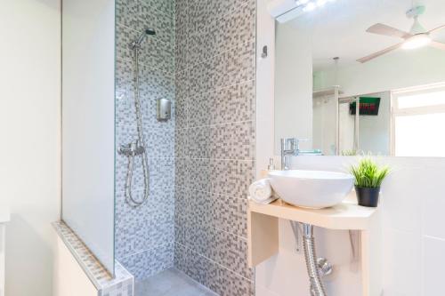 a white bathroom with a sink and a shower at Villa Neon Tenerife in Arona