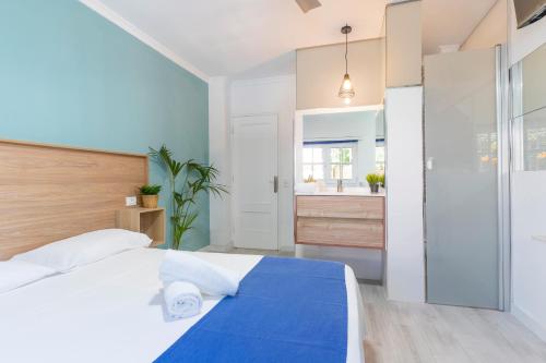 a bedroom with a large bed and a bathroom at Guest house Villa Neon Tenerife in Arona