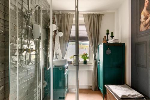 a bathroom with a glass shower with a sink at Neidorf Inn in Neudorf