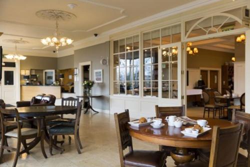 a dining room with a table and chairs at West Cork Hotel in Skibbereen