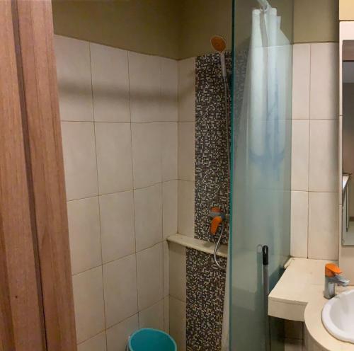 een badkamer met een douche en een wastafel bij Student Park 523 in Seturan