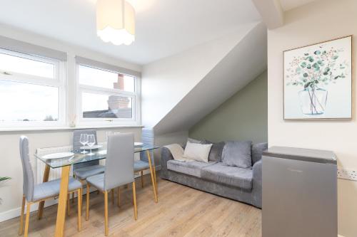 a living room with a table and a couch at Cosy Apartment Coventry City Centre in Coventry