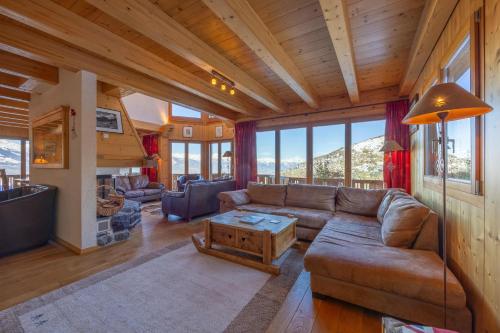 a living room with a couch and a table at Chalet Vansamis, breathtakinng views & sauna in Nendaz