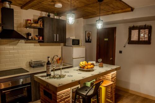 a kitchen with a bowl of fruit on a counter at Rural EL METGE Penáguila con chimenea in Penáguila