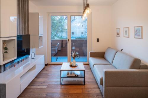 a living room with a couch and a table at RiverVista Apartments by mi_vida in Bad Waltersdorf