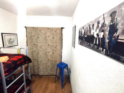 a room with a bed and a wall with a picture at Rural EL METGE Penáguila con chimenea in Penáguila