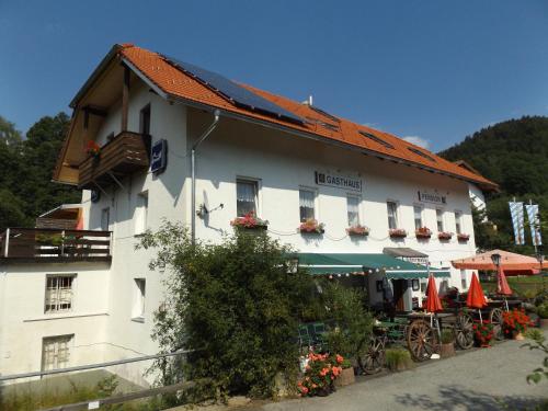 a large white building with umbrellas in front of it at Gasthaus Zehrermühle in Schönberg
