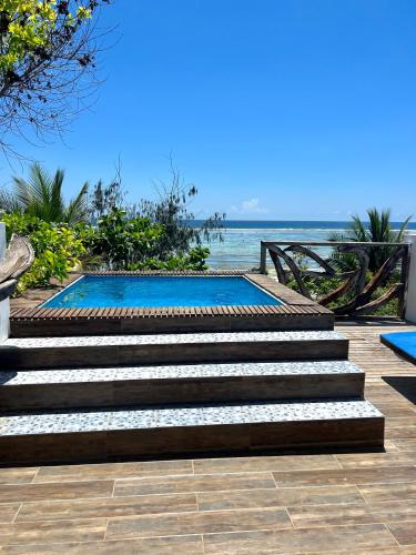 a set of stairs leading to a swimming pool at Zi Villa Dhow Beach Cottage in Matemwe