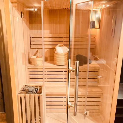 a walk in shower with a glass door at Au coeur du 11 in Beyne-Heusay
