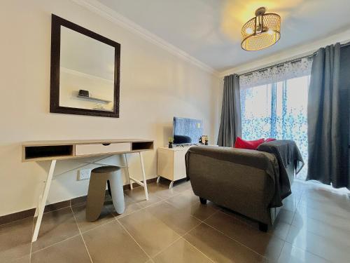 a bedroom with a desk and a chair and a mirror at Jirah@Riverside in Centurion