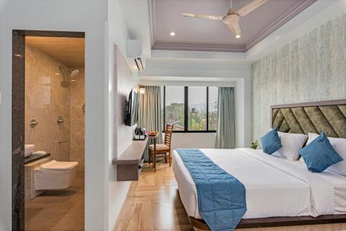 a hotel room with a bed and a bathroom at Emerald Retreat in Lonavala