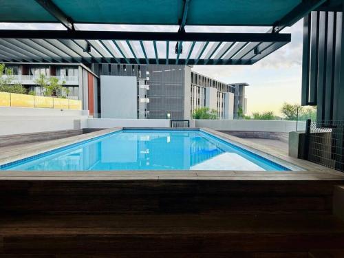 a large blue swimming pool in a building at Sibaya Umhlanga Apartments in Umhlanga