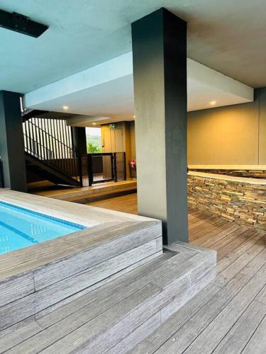a house with a swimming pool and a staircase at Ocean Dunes Bachelor Apartments in Umhlanga