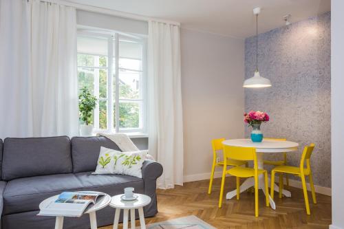 a living room with a couch and a table at Baker Street in Warsaw