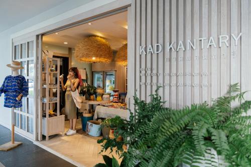 a woman standing in front of a kadj karma store at Kantary Hills Hotel, Chiang Mai in Chiang Mai