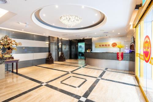 a lobby with a checkered floor and a chandelier at Etung Hotel in Taichung