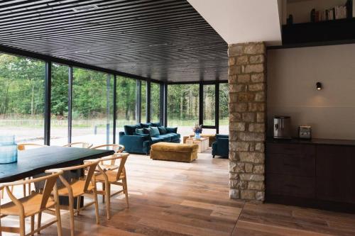 a living room with a table and chairs at Magnifique ferme rénovée in Plélan-le-Petit