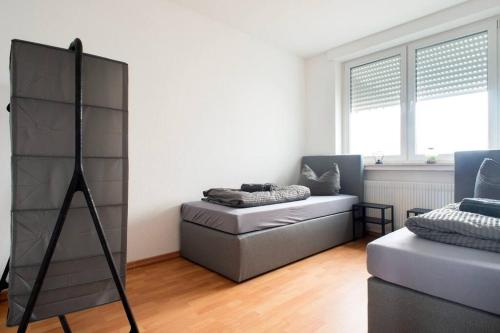 a living room with a couch and a chair at Modernes großräumiges Apartment - zwei Bäder in Gronau