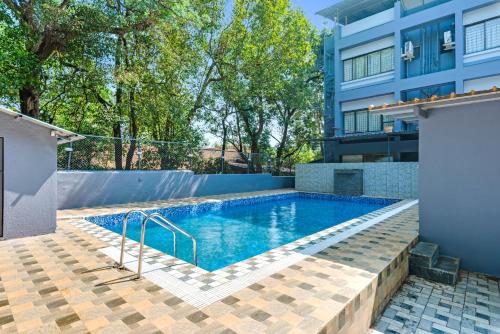 a swimming pool in front of a building at Emerald Retreat in Lonavala