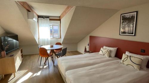 una habitación de hotel con una cama grande y una mesa en Résidence Les Baladines, en Thonon-les-Bains