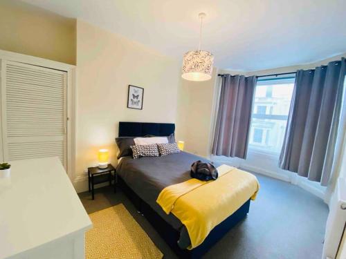 una camera da letto con un letto con uno zaino sopra di 7 Bedroom House in Town Centre near Beach - Sleeps 13 a Hastings