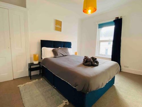 a bedroom with a bed with a stuffed animal on it at 7 Bedroom House in Town Centre near Beach - Sleeps 13 in Hastings