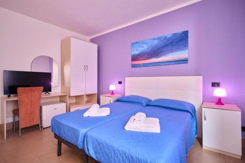 En eller flere senge i et værelse på Hotel Villa Del Mar