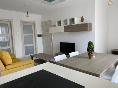 a living room with a table and a couch and a television at Msida Suites in Msida