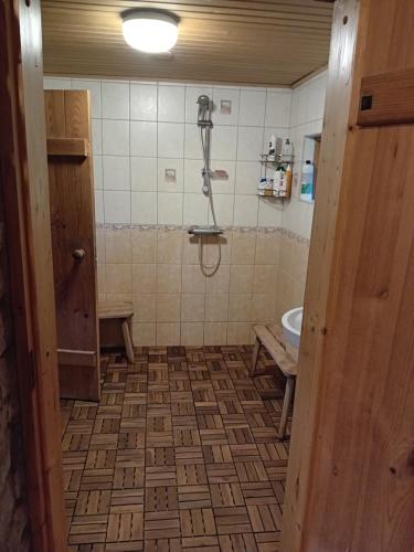 a bathroom with a shower and a sink at Romantiline saunamaja Pädaste lahe ääres in Pädaste