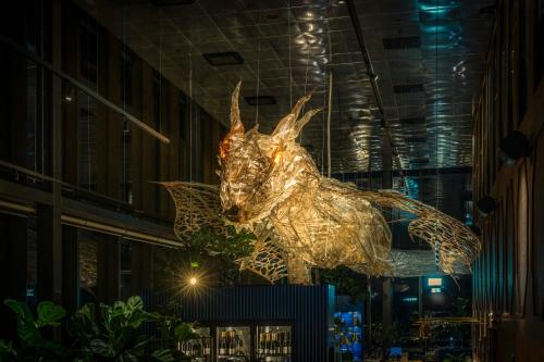 eine Statue eines Drachen, der von der Decke eines Gebäudes hängt in der Unterkunft Clarion Hotel Draken in Göteborg