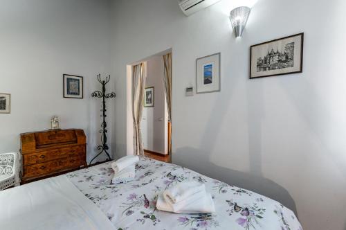 a bedroom with a bed and a dresser at Arno River Quiet Apartment in Florence
