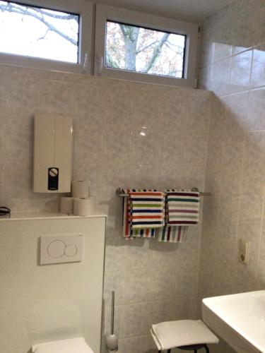 a bathroom with a toilet and a sink and a window at #office in Bengel