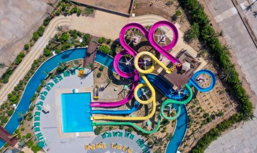 an overhead view of a pool with a water park at Calimera Blend Paradise in Hurghada