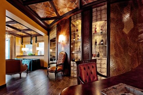 a bar with a table and chairs in a room at Tschuggen Grand Hotel - The Leading Hotels of the World in Arosa