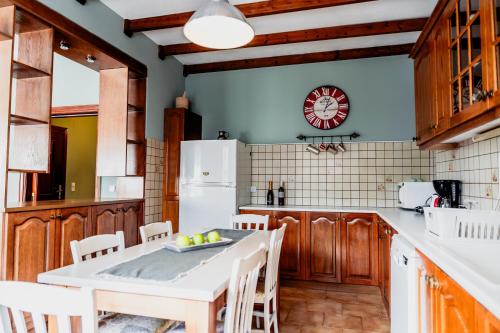a kitchen with wooden cabinets and a table and chairs at Va Yia/ Spacious guest house in Nafplio