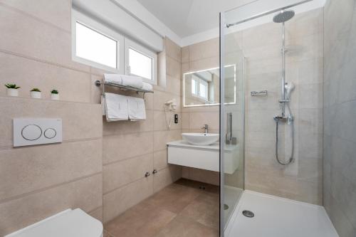 a bathroom with a shower and a sink at Villa Antares in Duće