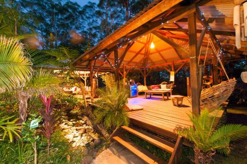 a wooden deck with a hammock and a tent at Alaya Ascend in Eudlo