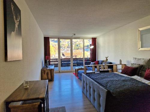 a living room with a bed and a couch at Tegernsee Apartment 2 min zum See in Tegernsee