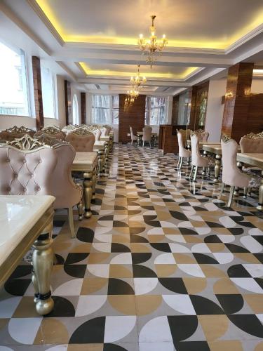 a large room with chairs and a checkerboard floor at Villasita resort By Montrose11 in Kasauli
