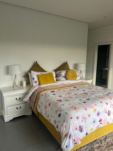 a bedroom with a large bed and a night stand at Luxurious Ballito Self Catering Family Holiday Home in Ballito