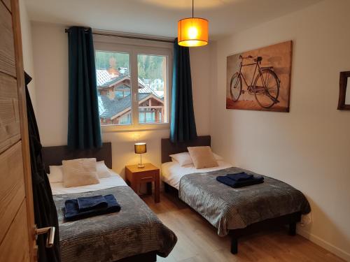 um quarto com duas camas e uma bicicleta na parede em Apartment Le Panoramic em Chamonix-Mont-Blanc