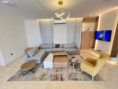 a living room with a couch and a table and chairs at Dibba Mountain Park Resort in Fujairah
