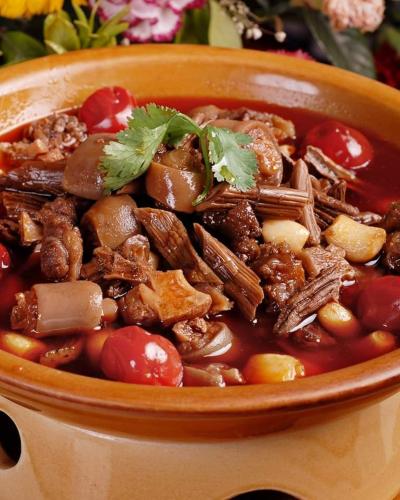 a bowl of food with meat and vegetables at Ocean Delight Boutique Hotel 海悦精品酒店 in Sihanoukville