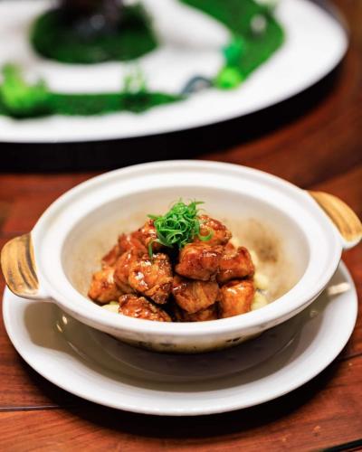 a bowl of soup on a plate on a table at Ocean Delight Boutique Hotel 海悦精品酒店 in Sihanoukville