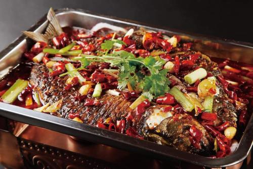 a dish of food with meat and vegetables in a pan at Ocean Delight Boutique Hotel 海悦精品酒店 in Sihanoukville