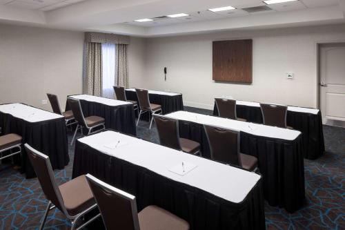a conference room with tables and chairs and a podium at Hampton Inn & Suites Panama City Beach-Pier Park Area in Panama City Beach