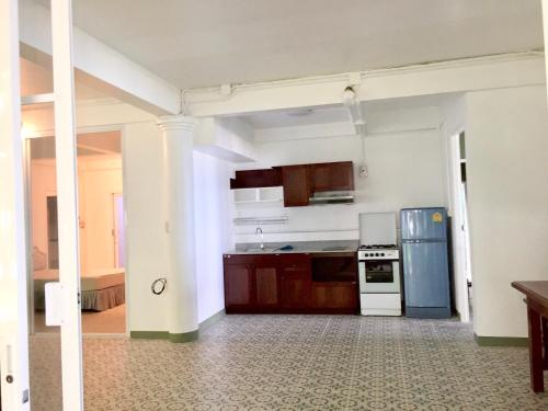 an empty kitchen with a stove and a refrigerator at Baan Napapan Beach Front, Hua Hin in Hua Hin