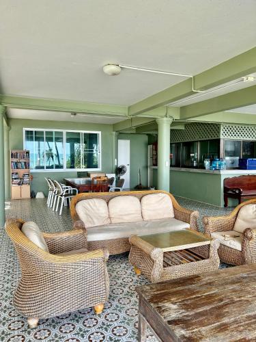 a living room with a couch and chairs and a table at Baan Napapan Beach Front, Hua Hin in Hua Hin